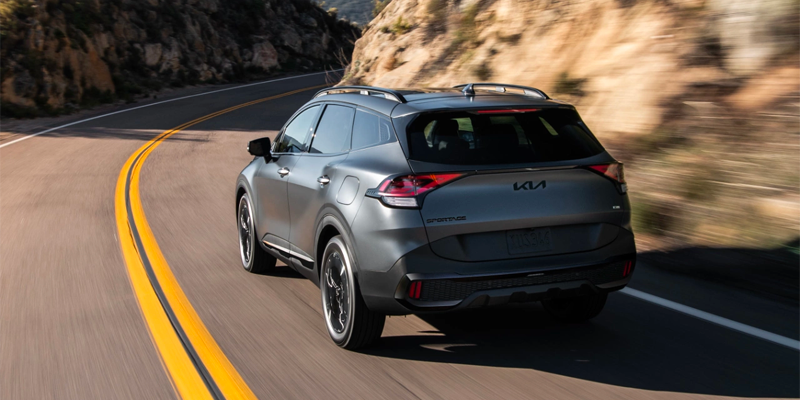 a grey 2025 Kia Sorento Plug-In Hybrid driving down a paved road